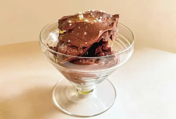 Glace au chocolat intense, parsemée de sel de mer et d'un filet d'huile dorée. Une délicieuse ganache coco pour un plaisir gourmand.